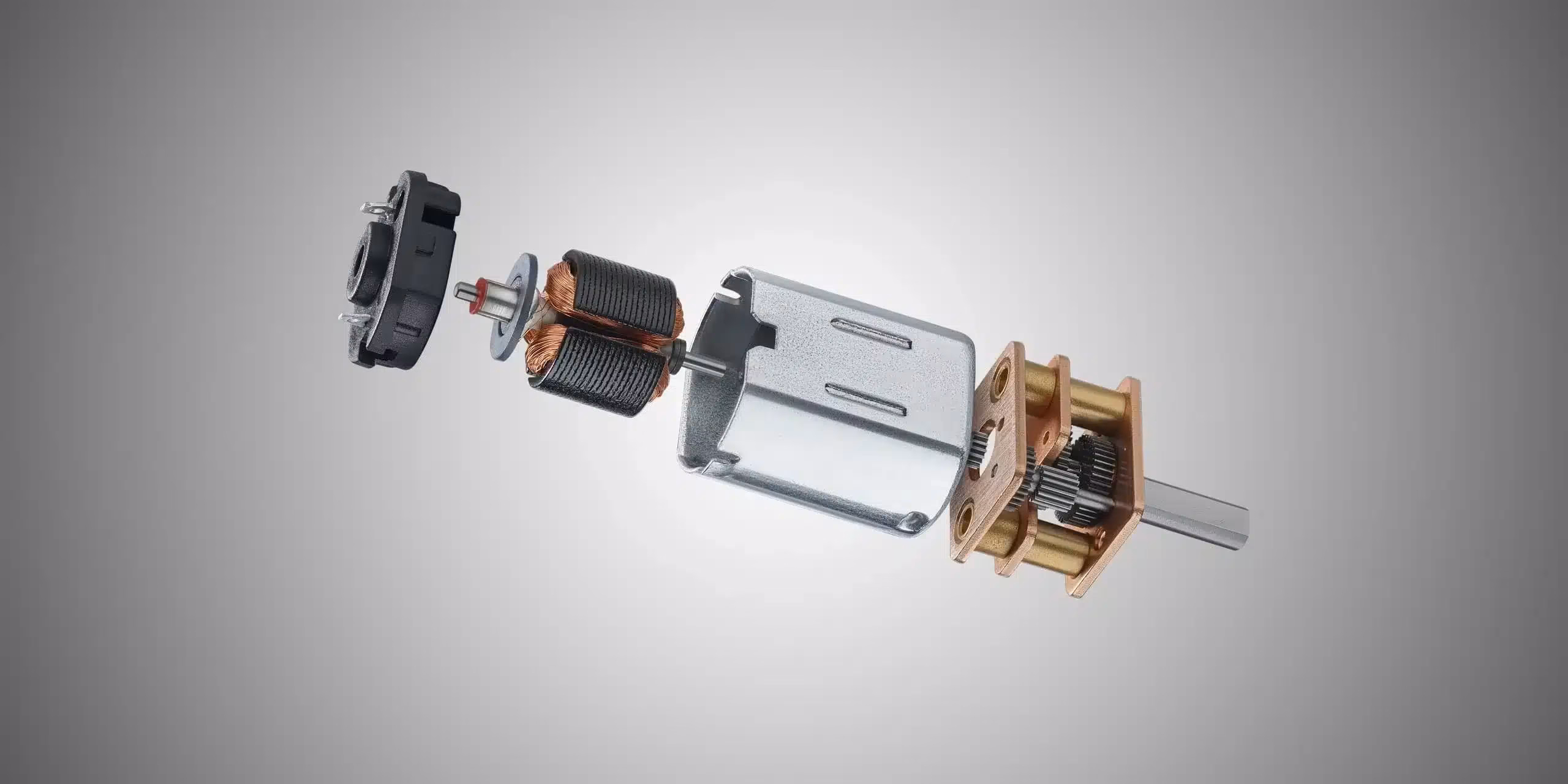 KOCO MOTION DC-Mikromotor mit Messingzahnrad-Getriebe – 3D-Explosionsansicht zeigt Motorgehäuse, Anker mit Kupferwicklung und Getriebestufen